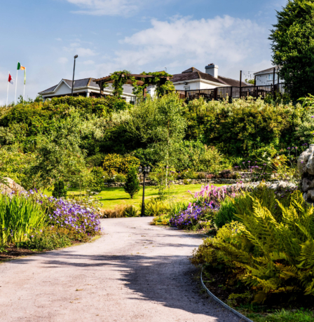 Family enjoying gardens at Fernhill House Hotel, with vibrant flowers and bright skies.