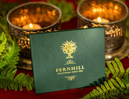 Fernhill House Hotel candlelit ambience with decorative ferns and elegant branding.