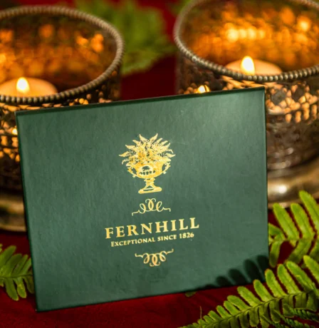 Fernhill House Hotel candlelit ambience with decorative ferns and elegant branding.