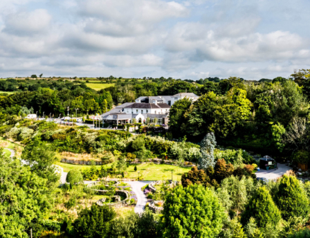 Aerial view of Fernhill House Hotel surrounded by lush gardens and countryside.