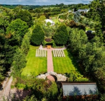 Serene outdoor wedding setup in lush gardens at Fernhill House Hotel.