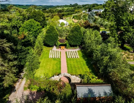 Aerial view of Fernhill House Hotel garden with chairs set up for a wedding ceremony.