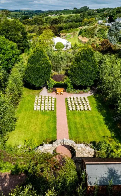 Aerial view of Fernhill House Hotel garden with chairs set up for a wedding ceremony.