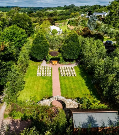 Aerial view of Fernhill House Hotel garden with chairs set up for a wedding ceremony.