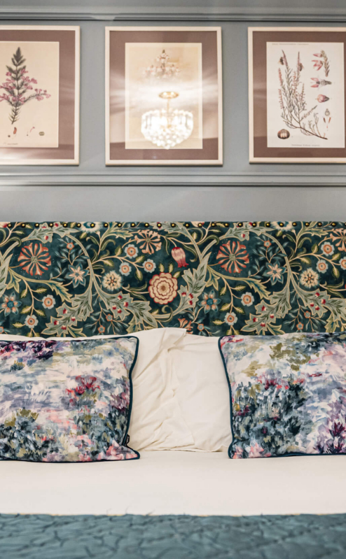 Elegant hotel room with floral decor and cosy lighting.