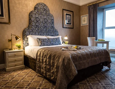 Cosy hotel room with elegant decor and large window, arranged for guest comfort
