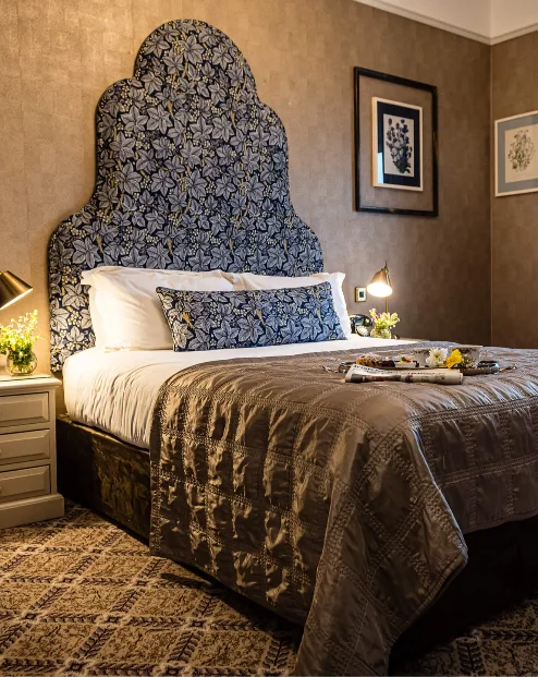 Cosy hotel room with elegant decor and large window, arranged for guest comfort
