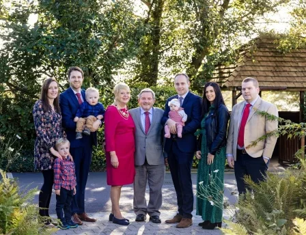 A joyful family gathers in garden at Fernhill House Hotel.