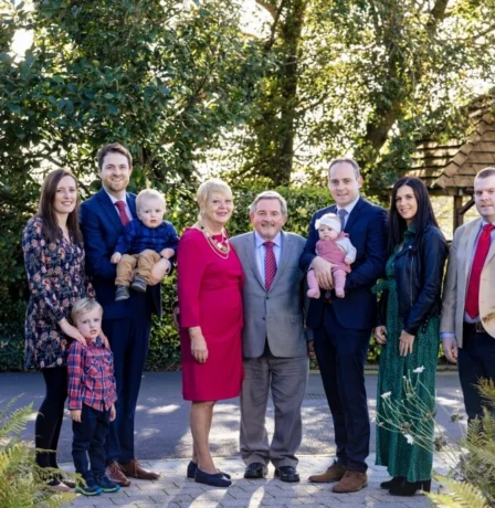 A joyful family gathers in garden at Fernhill House Hotel.