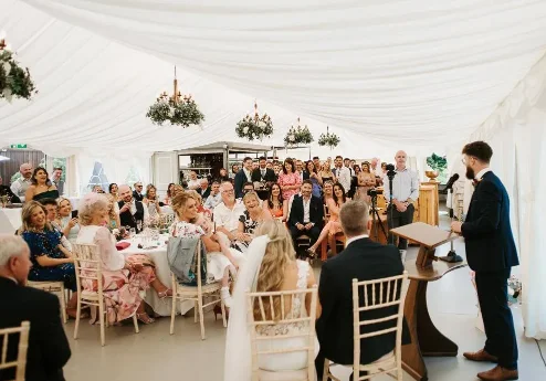 Family gathering in a bright marquee at Fernhill House Hotel.