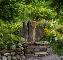 Serene garden with stone feature at Fernhill House Hotel.