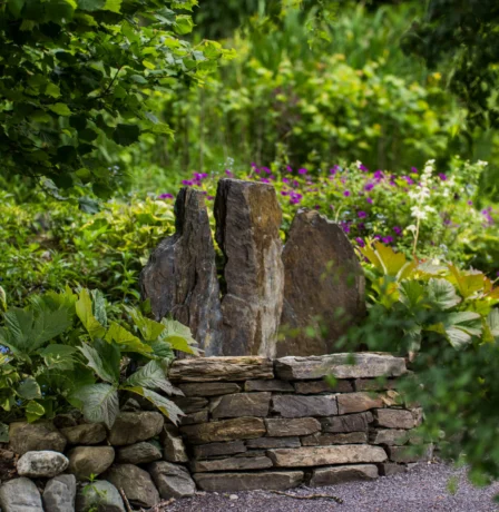 Serene garden with stone feature at Fernhill House Hotel.
