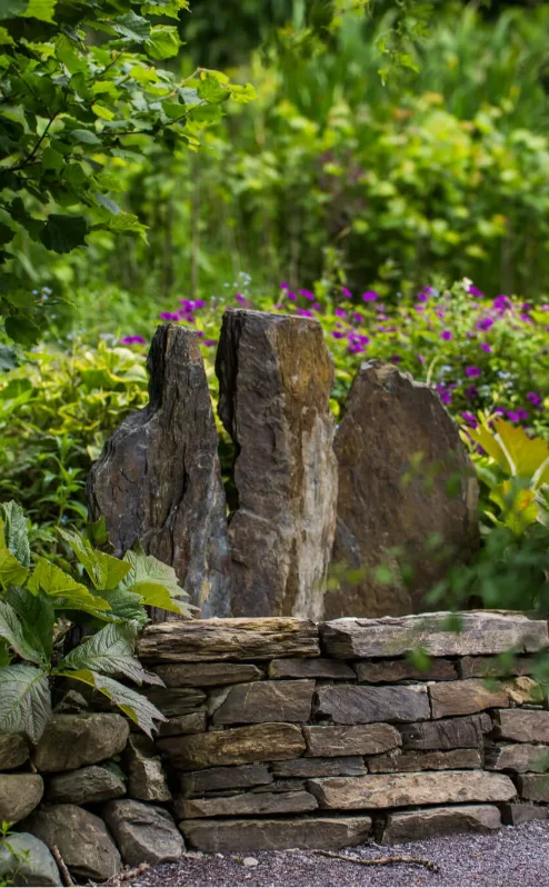Serene garden with stone feature at Fernhill House Hotel.