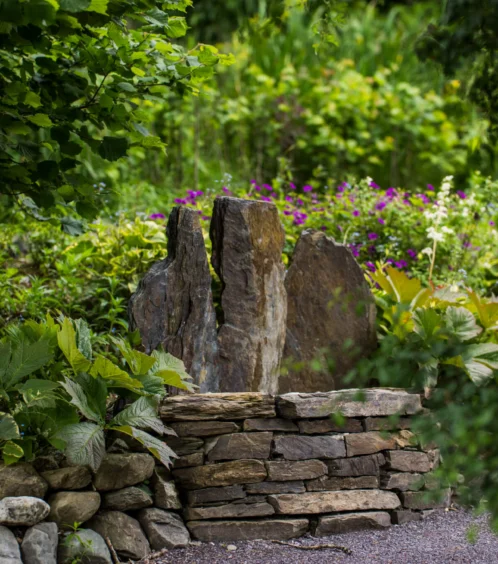 Serene garden with stone feature at Fernhill House Hotel.