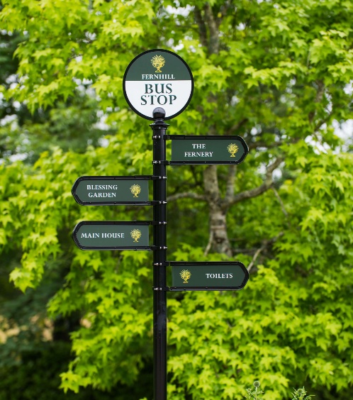 Signpost in scenic Fernhill gardens with directions to main areas.