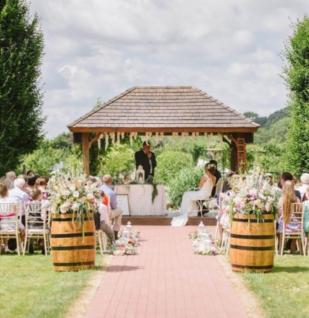 Outdoor wedding ceremony at Fernhill House Hotel with guests seated on a sunny day.