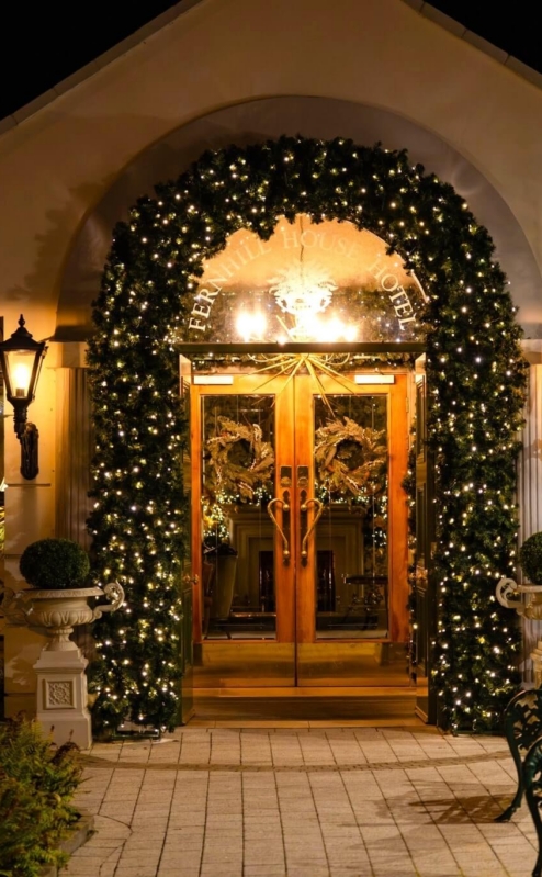 Fernhill House Hotel entrance adorned with festive lights, creating a warm welcome.