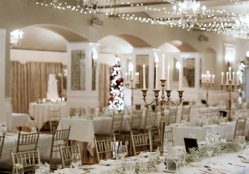 Elegant wedding reception with chandeliers and festive decor at Fernhill House Hotel.
