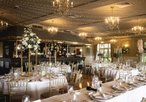 Elegant event room at Fernhill House Hotel set for a family celebration with candles and floral décor.