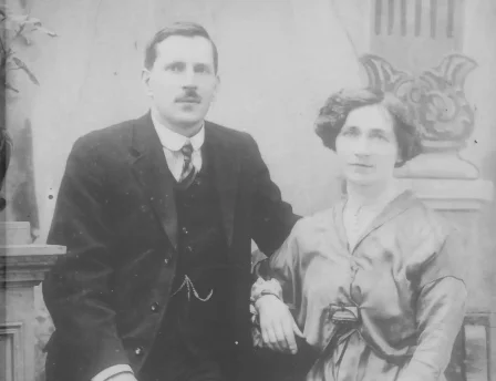 Vintage photo of a couple in formal attire, sitting together at Fernhill House Hotel.