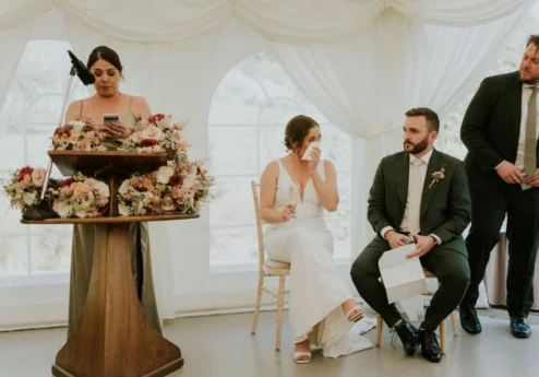 A couple enjoys a heartfelt speech during their wedding at Fernhill House Hotel.