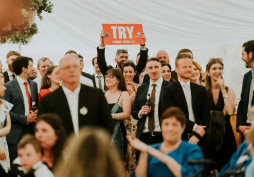 Group celebrating at Fernhill House Hotel event with a "Try" sign