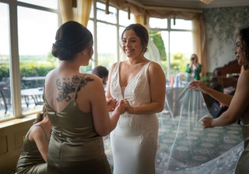 Bride with bridesmaids in elegant room preparing for a wedding at Fernhill House Hotel.