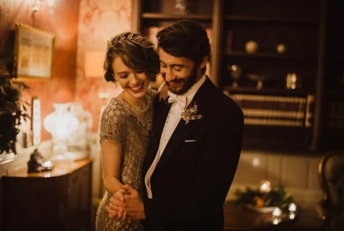 A smiling couple dancing in an elegant lounge with warm lighting at Fernhill House Hotel.