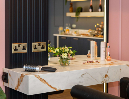 Stylish salon area with fresh flowers and hair products at Fernhill House Hotel.