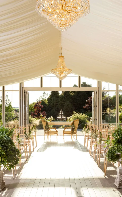 Elegant wedding venue with chandeliers and garden view at Fernhill House Hotel.