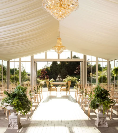 Elegant wedding venue with chandeliers and garden view at Fernhill House Hotel.