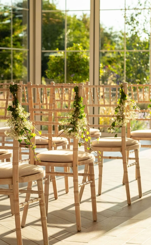 Sunlit event space with elegant chairs at Fernhill House Hotel, ready for a gathering.