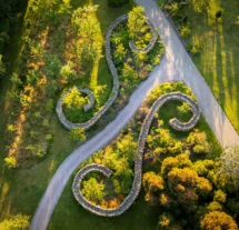 A serene aerial view of Fernhill House Hotel gardens with winding stone pathways and lush greenery.