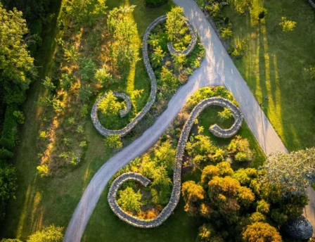 A serene aerial view of Fernhill House Hotel gardens with winding stone pathways and lush greenery.