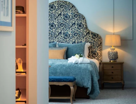 Elegant hotel room with plush bedding and warm lighting.