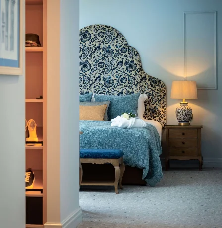 Elegant hotel room with plush bedding and warm lighting.