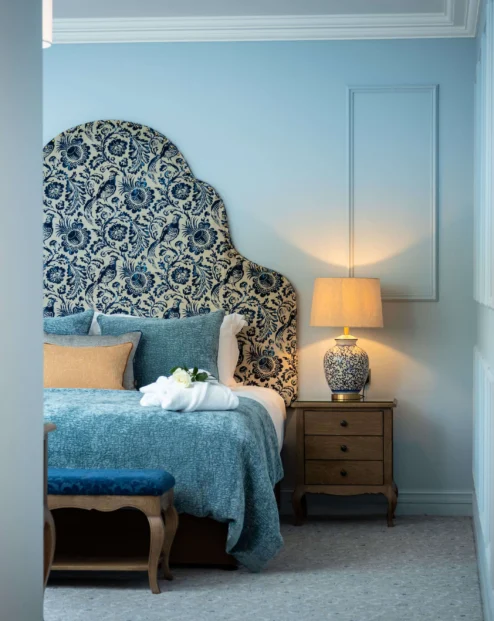 Elegant hotel room with blue decor and welcoming ambience.