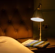Cosy hotel room with lamp lighting and West Cork book.