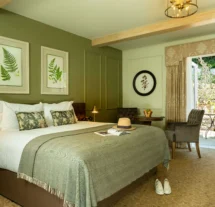 Cosy hotel room with double bed and view of a private garden patio.