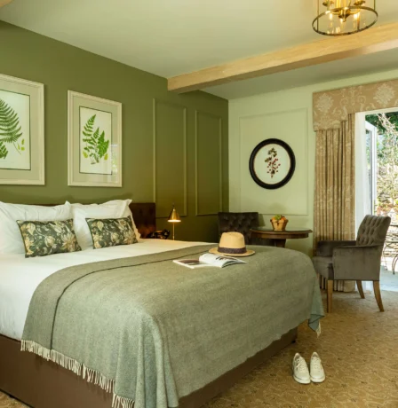 Cosy hotel room with double bed and view of a private garden patio.