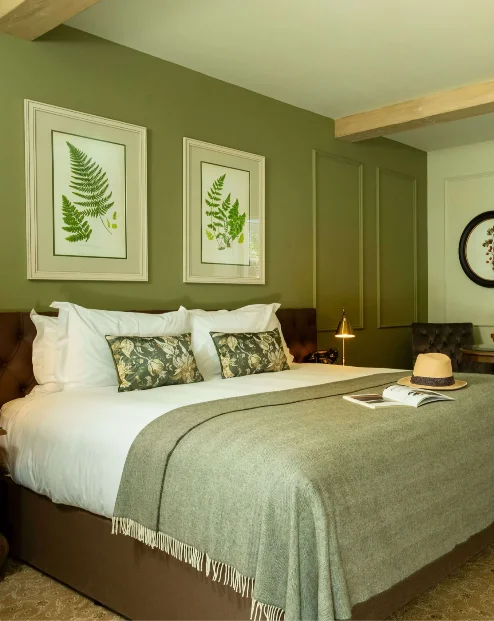 Cosy hotel room with double bed and view of a private garden patio.