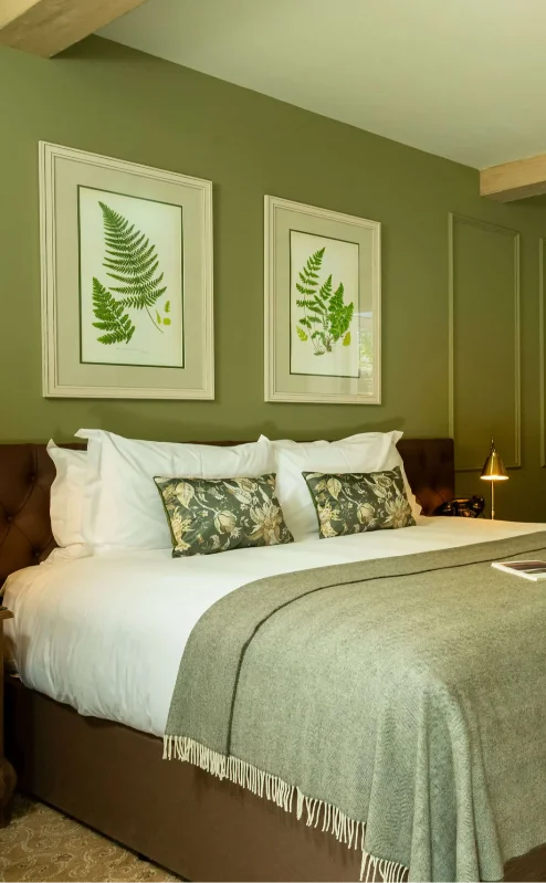 Cosy hotel room with double bed and view of a private garden patio.