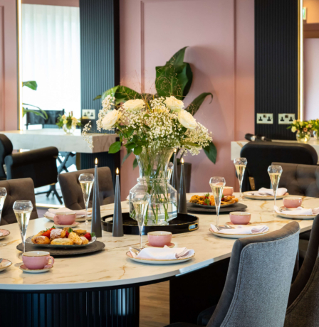 Elegant dining room setup at Fernhill House Hotel with floral centrepiece.