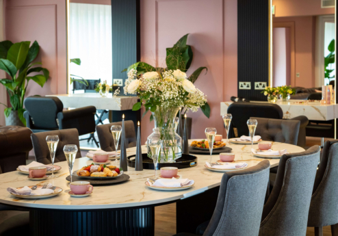 Elegant dining room setup at Fernhill House Hotel with floral centrepiece.