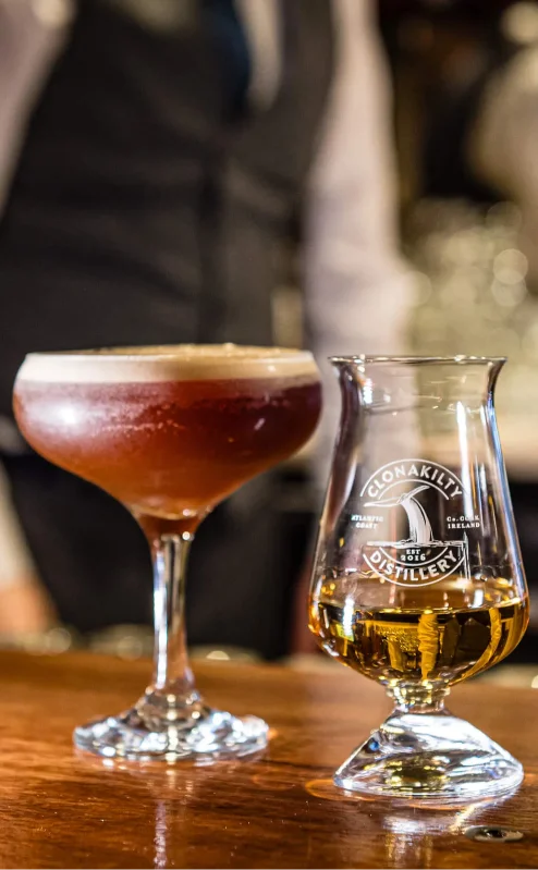 Hotel bar with cocktails, whisky, and a bartender ready to serve.