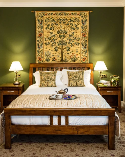 Cosy hotel room with a large bed, elegant decor, and a warm, inviting atmosphere.