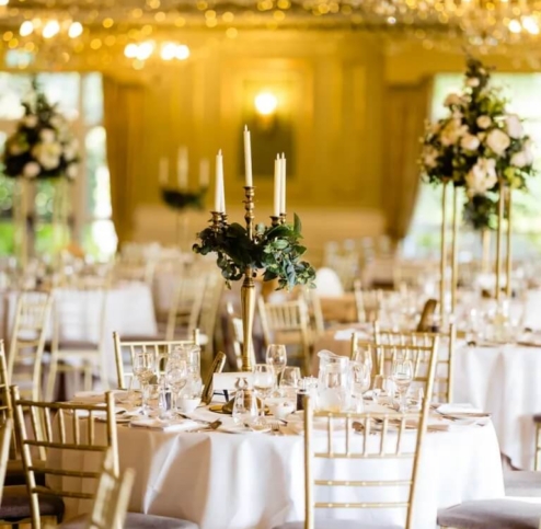 Elegant banquet hall with candlelit tables and floral centrepieces at Fernhill House Hotel.