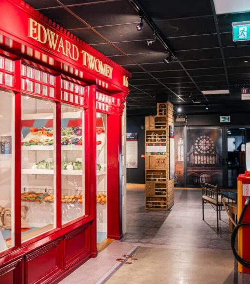 Family exploring Fernhill House Hotel's vibrant corridor with red storefront.
