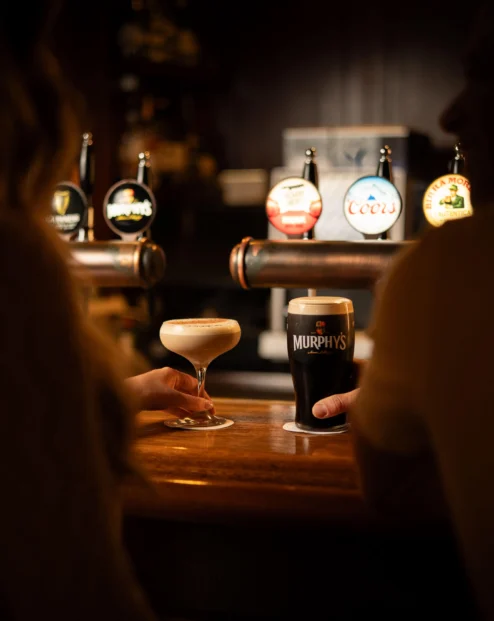 Couple enjoying drinks at Fernhill House Hotel bar.