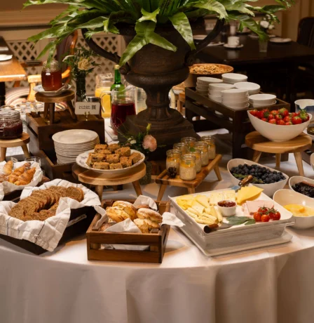 A welcoming breakfast buffet with pastries, fruits, and drinks at Fernhill House Hotel.